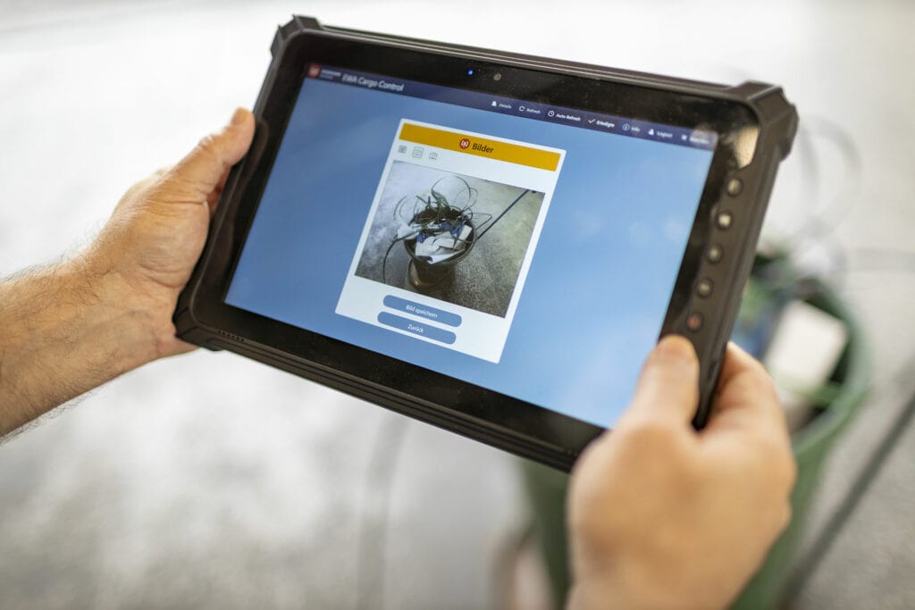Person betrachtet Helm auf Tablet