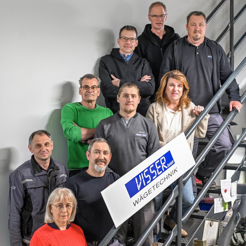 Team photo on stairs with company sign